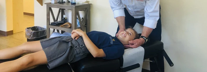 Chiropractor Oro Valley AZ Daniel Marsh Adjusting Child Neck Pain